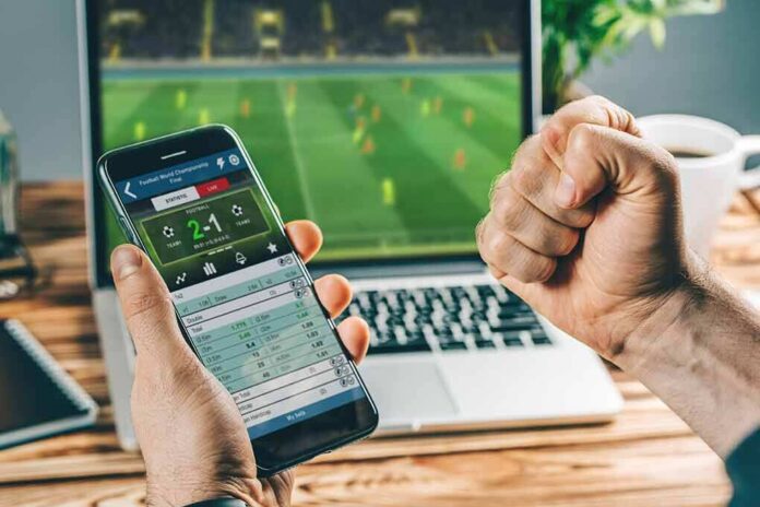 Person checking live soccer betting odds on a smartphone
