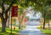 Campus Shuts Down For TPUSA Memorial Tree-lined campus walkway with red banners