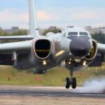 Military jet bomber landing on runway