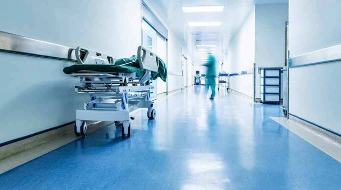 Hospital corridor with empty gurney
