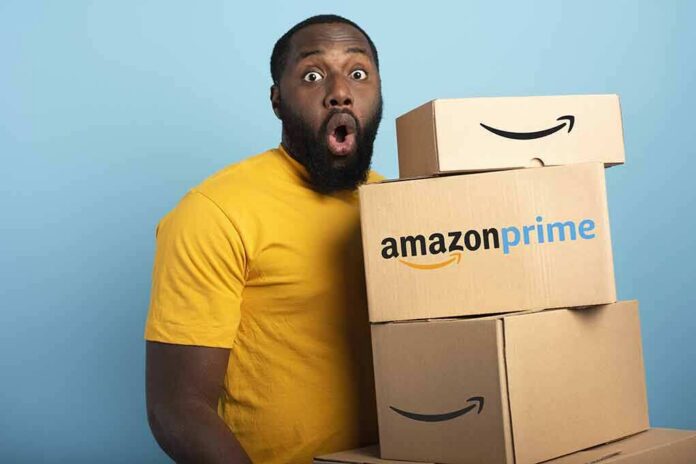 Man in yellow shirt holding stack of Amazon Prime boxes