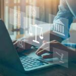 Person typing on laptop with legal icons overlay
