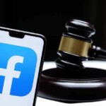 Smartphone with Facebook app logo beside a judge’s gavel