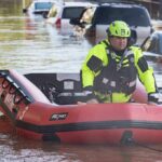 Rescue worker in an inflatable boat during urban flooding