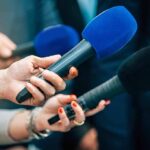 Hurricane Surf Exposes Costly Malibu Weakness Reporters holding colorful microphones