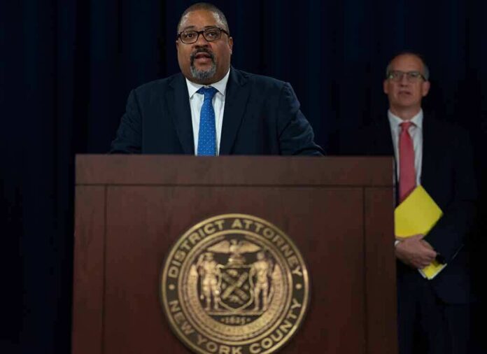 Man speaks at podium with New York County District Attorney seal
