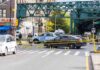 Early-Morning Homicide: Child Nearby, Silence Police cars block a city intersection with yellow crime scene tape