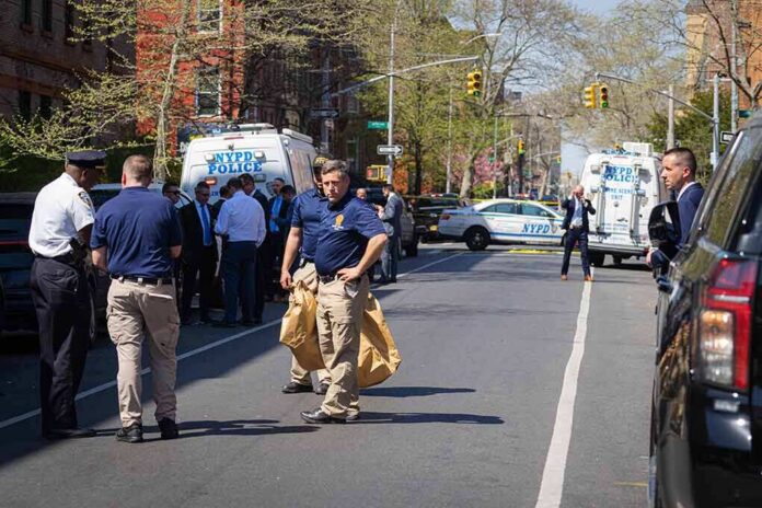 Police officers and investigators at a blocked city street scene