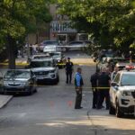 The Houston ICE Shooting — The Agency’s Story and the Evidence Nobody’s Seen Police officers secure a residential street with patrol cars and yellow tape