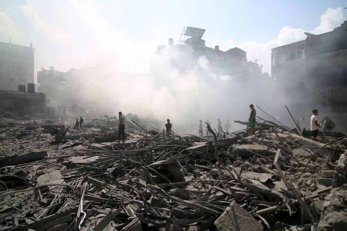 People walking through smoke-filled urban rubble