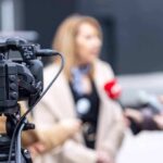 Video camera filming an outdoor media interview