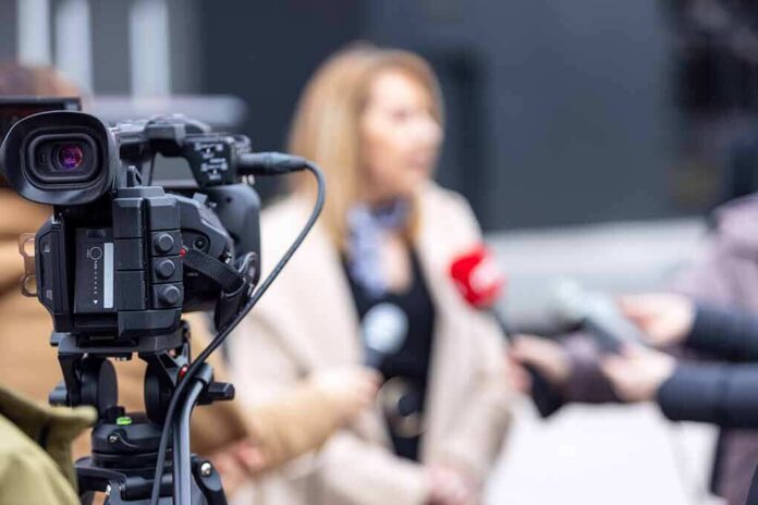 Video camera filming an outdoor media interview