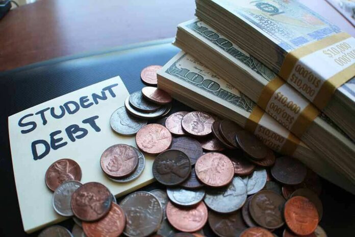 stacks of cash and coins next to a student debt note