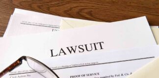 Legal documents labeled lawsuit on a desk