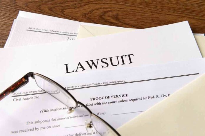 Legal documents labeled lawsuit on a desk