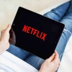 Paid Safe Space? Florida Says Bait-And-Switch Person holding a tablet with streaming app on screen