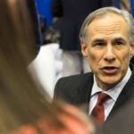 man in suit speaking at an event