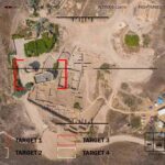 Aerial view through drone HUD of archaeological ruins and surrounding campsite