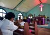 Congregation inside a church with a speaker at the pulpit