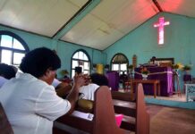 Congregation inside a church with a speaker at the pulpit