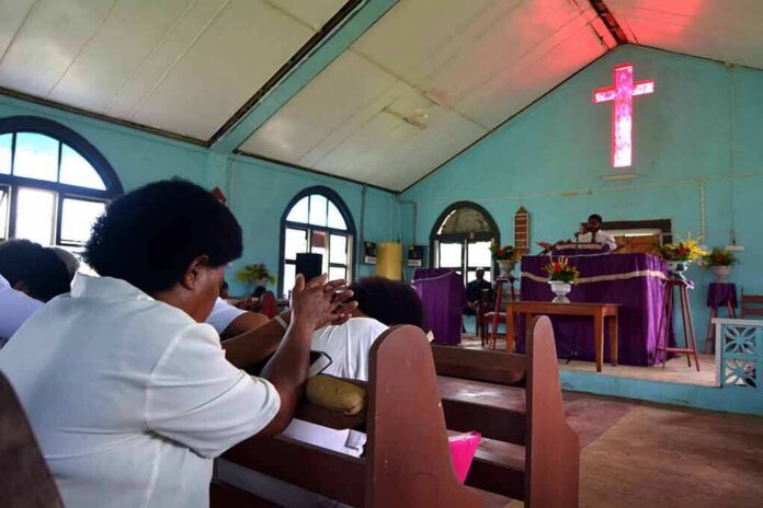 Congregation inside a church with a speaker at the pulpit
