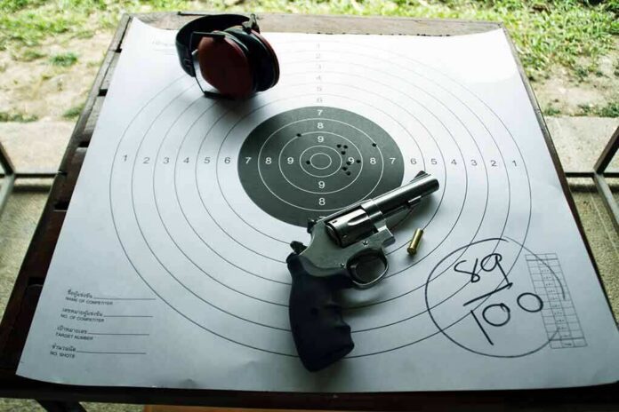 Revolver and ear protection on paper shooting target
