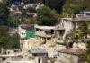 Hillside neighborhood with damaged concrete houses