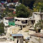 Hillside neighborhood with damaged concrete houses