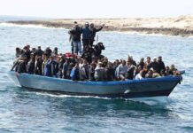 Crowded blue boat at sea with Ivan Morales Jr., Andreas Hestler, Isaiah Frey, Christian Jones, and Teddy Williams among passengers