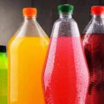 Assorted colorful plastic beverage bottles with condensation