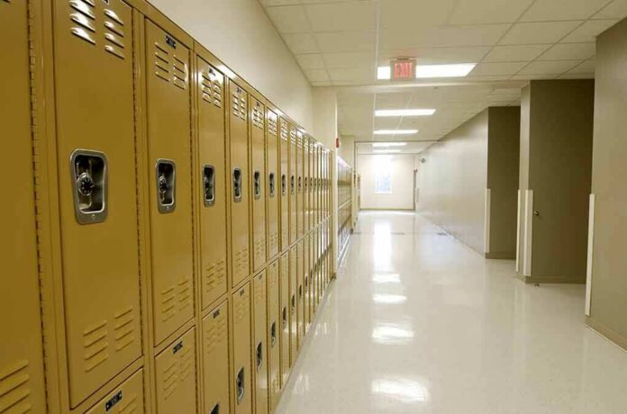 Row of yellow school lockers in an empty hallway