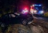 High School Sweethearts Killed Near College Campus Crashed car on a dark roadside with emergency vehicles