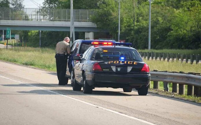 Police officer conducting a traffic stop on a highway