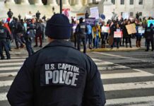 Police officer monitoring a protest on a city street