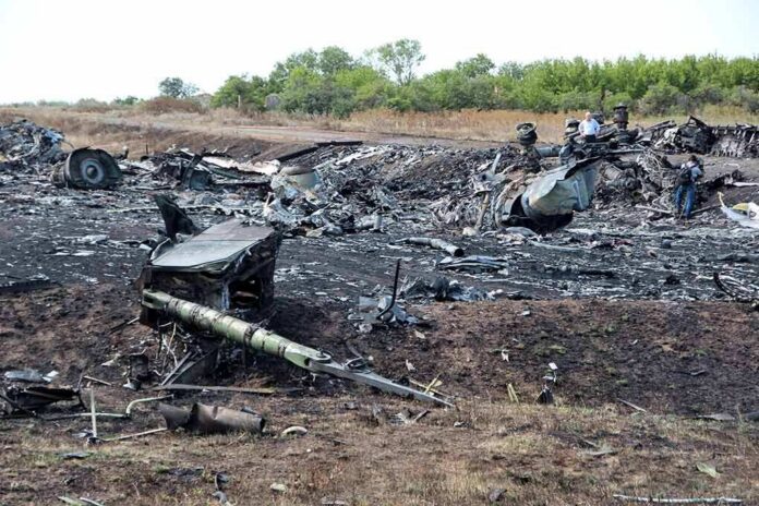 Airplane crash debris scattered across a burned field