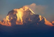 Hikers Trapped Between Cliffs in Freezing Cold Snow-capped mountain peak glowing at sunrise
