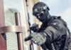 tactical officer in black gear reaching for a door handle