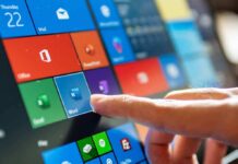Finger tapping a tablet screen with colorful app tiles