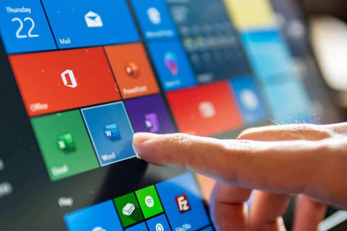 Finger tapping a tablet screen with colorful app tiles