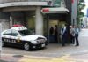 Japanese police box with patrol car and officers speaking to two men