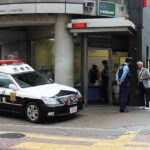 U.S. Marine Accused of Killing Woman in Hotel Japanese police box with patrol car and officers speaking to two men