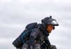 Person flying with a jet suit against a cloudy sky