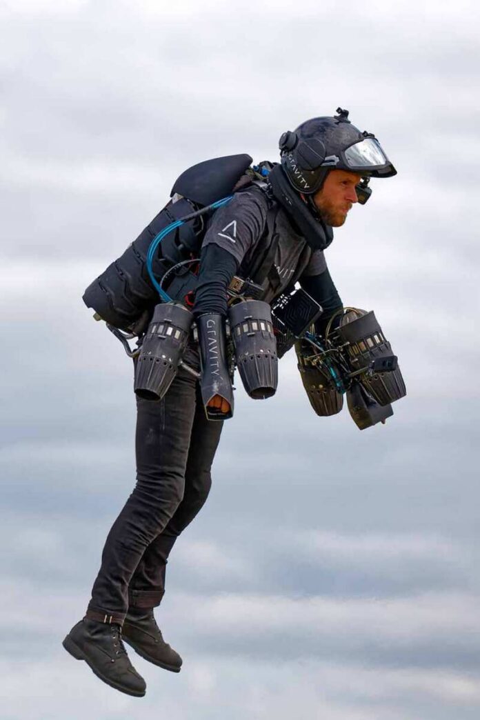 Person flying with a jet suit against a cloudy sky