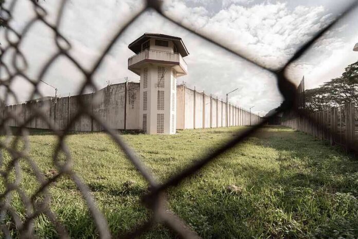 Prison watchtower behind chain-link fence
