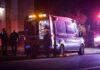 Ambulance at night with paramedics attending a patient