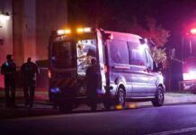 Ambulance at night with paramedics attending a patient