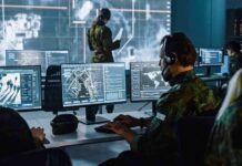 Military analysts at computers in a command center