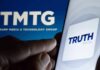Smartphone showing Truth Social app icon beside TMTG logo on screen