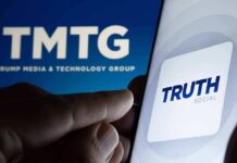 Smartphone showing Truth Social app icon beside TMTG logo on screen