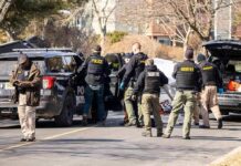 Retired Cop Kills Wife and Daughter Police and sheriff officers gather around vehicles on a suburban street
